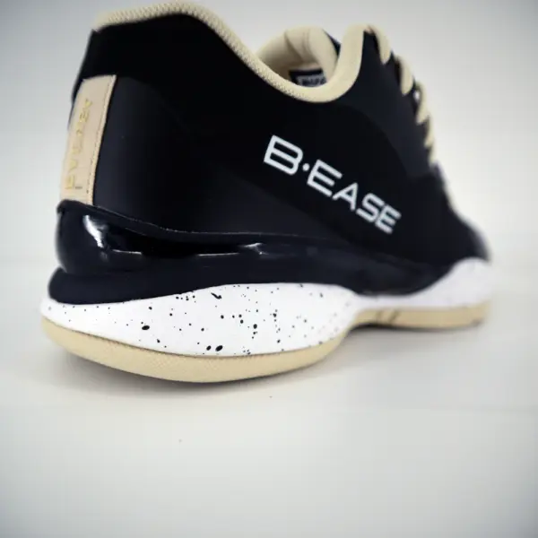 Chaussures de basketball B.EASE Suspended Low noir et crème vue sur la semelle arrière