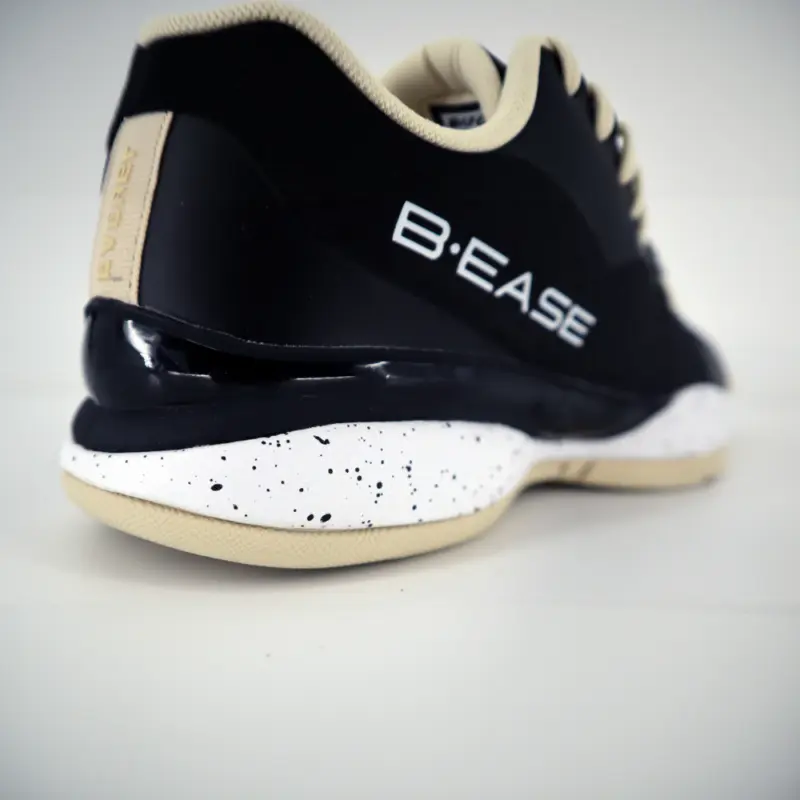 Chaussures de basketball B.EASE Suspended Low noir et crème vue sur la semelle arrière